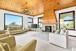 a living room with a fireplace and a tv at Mullaghmore Holiday Home in Cliffony