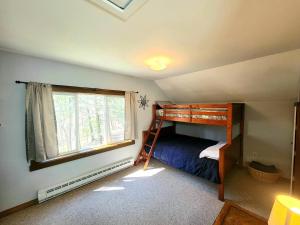 a bedroom with a bunk bed and a window at Morel Mountain Hideaway in Warren