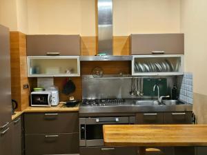 a kitchen with a sink and a stove top oven at Хостел Палац Спорта in Kyiv +7 photos