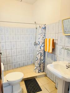 a bathroom with a toilet and a sink at Moragalla Relax Stay in Beruwala +23 photos