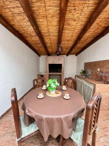 a dining room with a table and chairs and a fireplace at Casa campo Ayllu in Tilcara