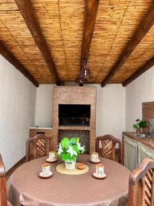 a dining room with a table and a fireplace at Casa campo Ayllu in Tilcara
