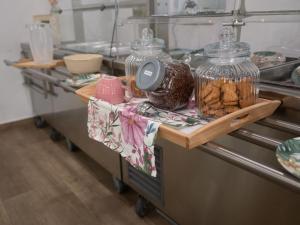 a counter in a kitchen with two jars of food at ROOMS alCentro in Catania