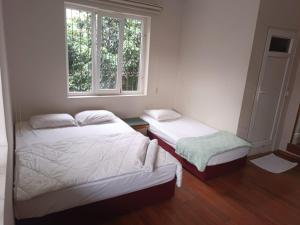 a bedroom with two beds and a window at Dilara Hotel Pansiyon in Antalya