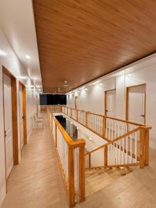 a room with a staircase with wooden railings in a building at AMIGOS Hostel El Nido in El Nido