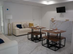 a living room with two tables and a couch at ROOMS alCentro in Catania