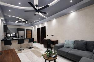 a living room with a couch and a ceiling fan at Kasa Nikte in Tulum