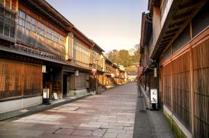 an empty street in an old town with buildings at HITOYADO kanazawa in Kanazawa