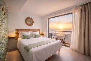 a bedroom with a large bed and a large window at Banana Garden La Palma in Santa Cruz de la Palma