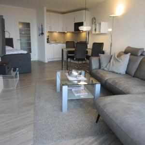 a living room with a couch and a table at Lord Nelson App. 302 in Cuxhaven