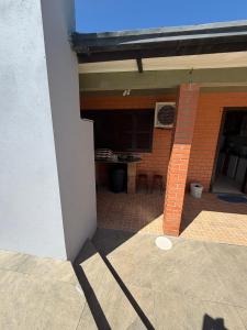an outside view of a building with a patio at Casa praia bella torres in Passo De Torres