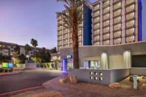a hotel with a palm tree in front of a building at Holiday Inn Express & Suites Phoenix - Midtown, an IHG Hotel in Phoenix