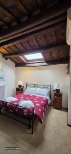 a bedroom with a bed with a red blanket at Skyline Virgilio SUITE sottotetto vista MARE parking in San Marino