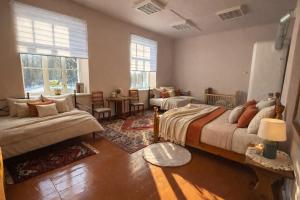 a bedroom with two beds and a living room at Viesnīca Meirānu Muiža in Meirāni