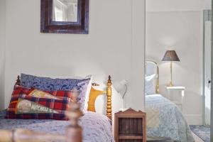 a bedroom with a bed and a mirror on the wall at Camp Red Lodge - Cozy & Convenient in Red Lodge