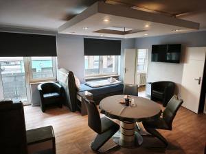 a living room with a table and a couch at Apartment Sofia in Düsseldorf