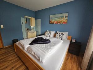 a bedroom with a large bed with a painting on the wall at Mirnockblick Apartments in Radenthein