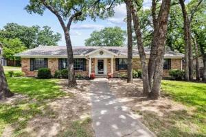 a brick house with a pathway in front of it at 4-Bedroom Home with Private Pool in Euless in Euless