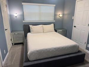 a small bedroom with a bed and a window at 4-Bedroom Home with Private Pool in Euless in Euless +16 photos