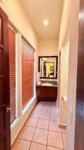 a bathroom with a sink and a mirror at Mayan Princess Beach & Dive Resort in West Bay
