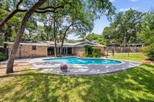 a house with a swimming pool in a yard at 4-Bedroom Home with Private Pool in Euless in Euless