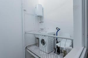 a laundry room with a washing machine and a sink at I profumi del centro in Prato +44 photos