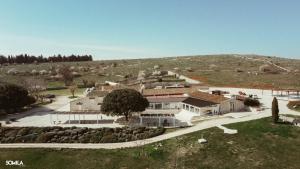 an aerial view of a large house in a field at Masseria Torre Di Nebbia in Castel del Monte