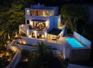 an aerial view of a house at night with a swimming pool at Villa Sitges Altavista Amazing View South oriented Calm Area AC Beach 2 minutes Drive and 18 minutes Walk in Sitges
