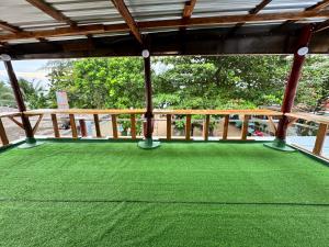 a covered porch with green grass on it at The Tent Naiyang in Nai Yang Beach +3 photos