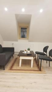 a living room with a coffee table and chairs at Apartmán Tonny in Jáchymov +1 photo