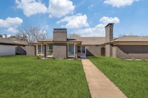 a brick house with a grass yard at La Fleur Chateau 4B 2B Duplex KING Pet Friendly in Richardson