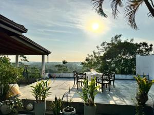 a patio with a table and chairs and the sunset at The Ellen Horizon in Baddegama