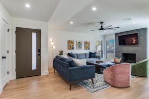a living room with a couch and a fireplace at La Fleur Chateau 4B 2B Duplex KING Pet Friendly in Richardson