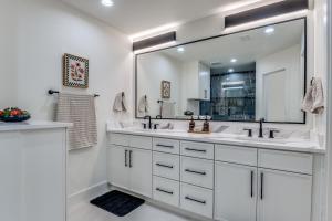 a white bathroom with two sinks and a large mirror at La Fleur Chateau 4B 2B Duplex KING Pet Friendly in Richardson +4 photos