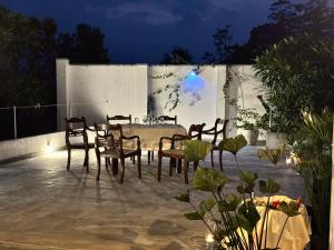 a table and chairs on a patio at night at The Ellen Horizon in Baddegama