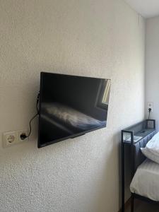 a flat screen tv hanging on a wall at Ferienwohnung Fatlume No 7 in Bad Honnef am Rhein