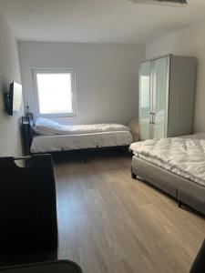 a room with two beds and a window at Ferienwohnung Fatlume No 7 in Bad Honnef am Rhein