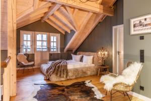 a room with a bed and a couch and chairs at Landhäuser Ottilienruh in Ilsenburg