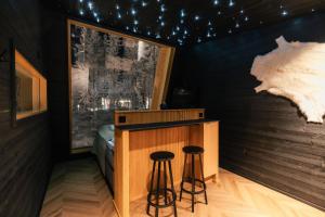 a room with two bar stools in a room at Lapland Glow Chalets in Rovaniemi