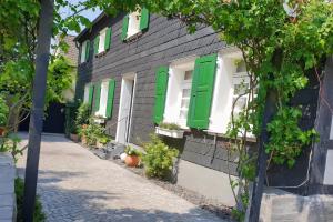 a building with green shutters and a street at Westfalenkrug in Wuppertal