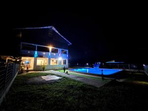a house with a swimming pool at night at RTMS Guesthouse Semporna in Semporna
