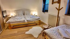 a bedroom with two twin beds and a rug at Chalet Olešnice in Olešnice v Orlických horách