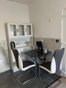 a table and two chairs in a room at Ferienwohnung Fatlume No 7 in Bad Honnef am Rhein