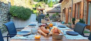 a wooden table with food on top of it at La petite Sorbonne - Chambres d'hôtes in Malleval