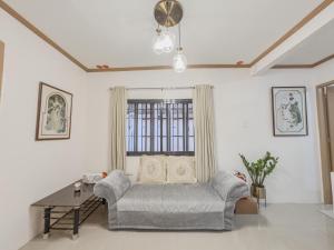 a living room with a couch and a table at La-Rivière Vacation Home in Lal-lo