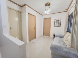 a living room with a couch and a window at La-Rivière Vacation Home in Lal-lo