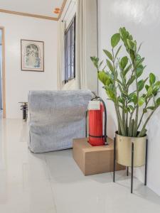 a living room with a fire hydrant and a potted plant at La-Rivière Vacation Home in Lal-lo +32 photos