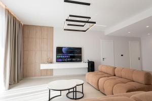 a living room with a couch and a table at Crystal 13 Villas in Ksamil