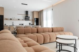 a living room with a large couch and tables at Crystal 13 Villas in Ksamil