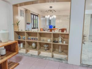 a room with shelves of vases and vases at La-Rivière Vacation Home in Lal-lo